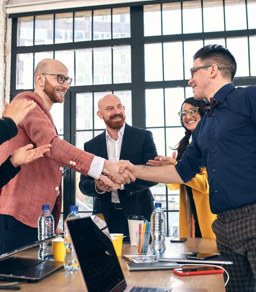 Business handshake at meeting or negotiation in the office. Partners are satisfied because signing contract or financial papers. selective focus.